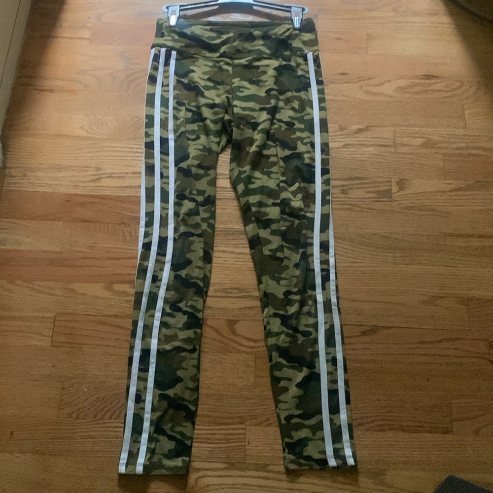 Army fatigue design leggings with white strips on one sides of the legs.